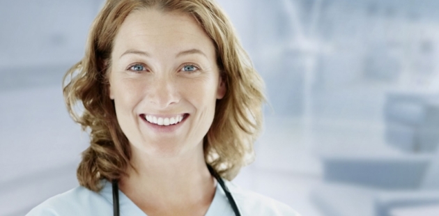 a female doctor in white coat smiling