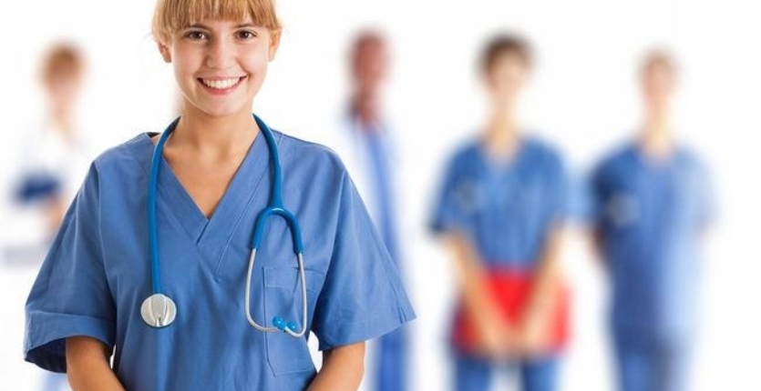 a female doctor in blue coat smiling